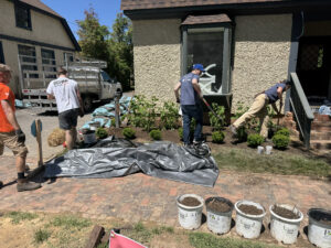 Volunteers work on the landscaping in front of Bette's Boutique in Asheville, N.C., as part of Heart on Main Street's Independent Rebuild Project.