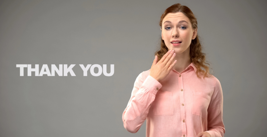 woman using ASL to sign "thank you"